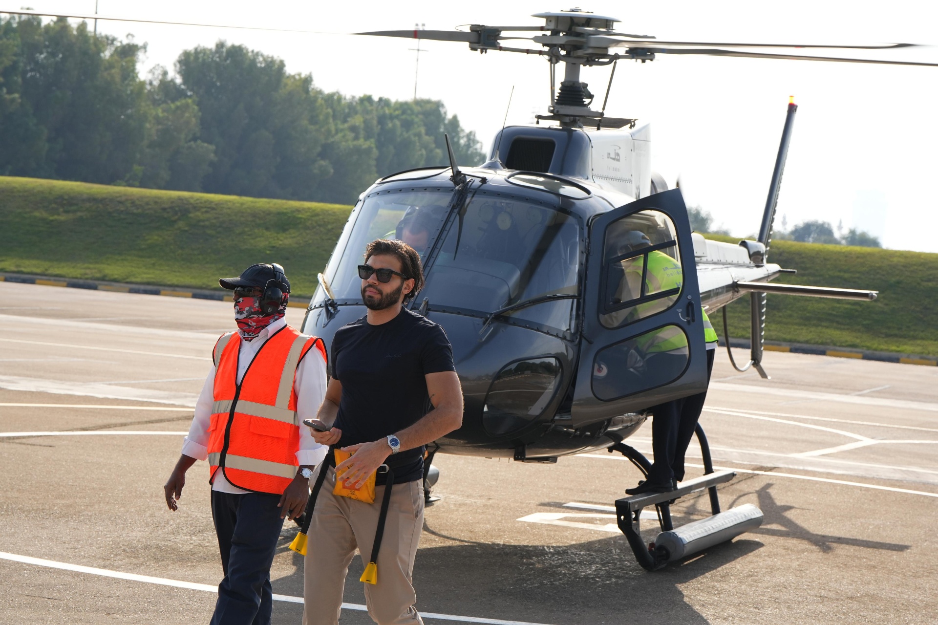 The founder walking off a helicopter